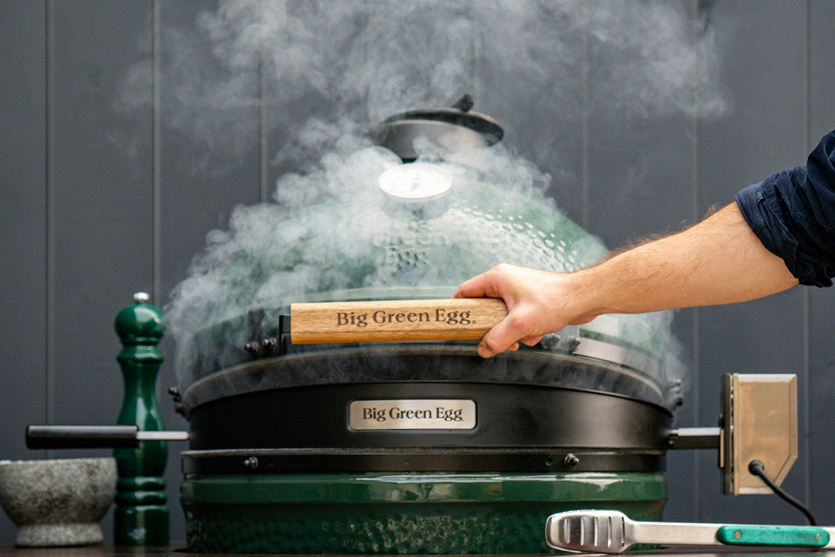 Big Green Egg in action with a smoking rotisserie, ideal for creating flavorful dishes in Northern Ireland and Ireland.