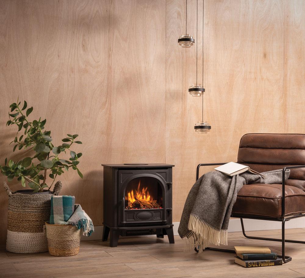 Gazco Stockton 5 electric stove beside a brown leather chair