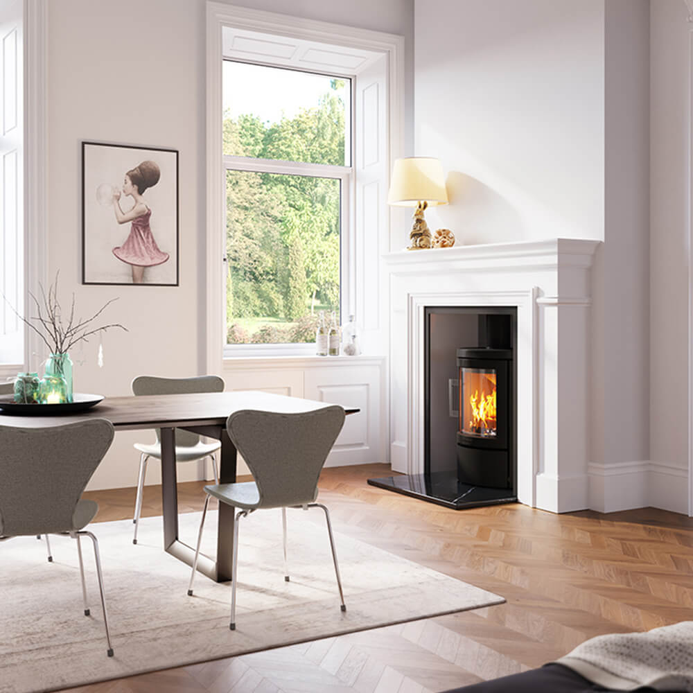 HWAM 2620c wood-burning stove beside a fireplace