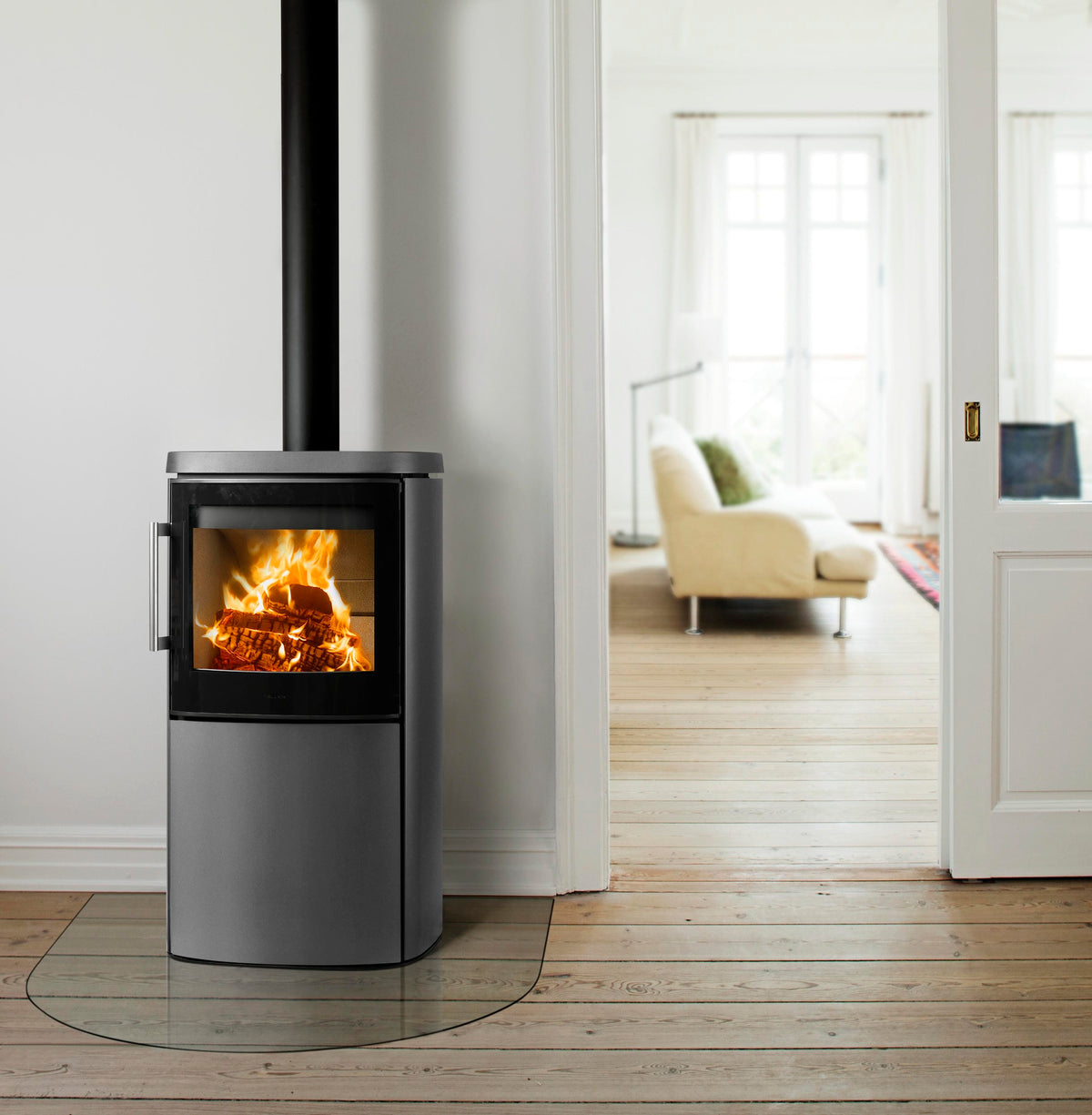 HWAM 4640 wood-burning stove in grey in a bright white room