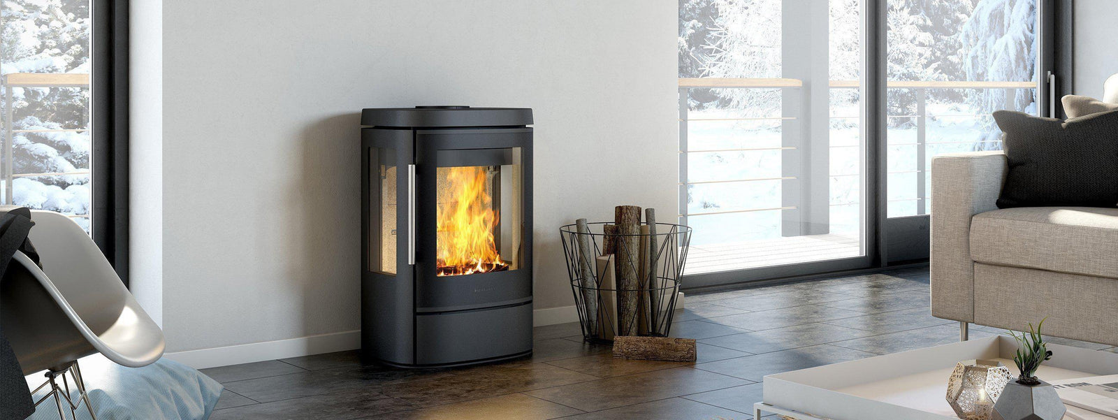 HWAM cylindrical stove beside full-height windows in a living room