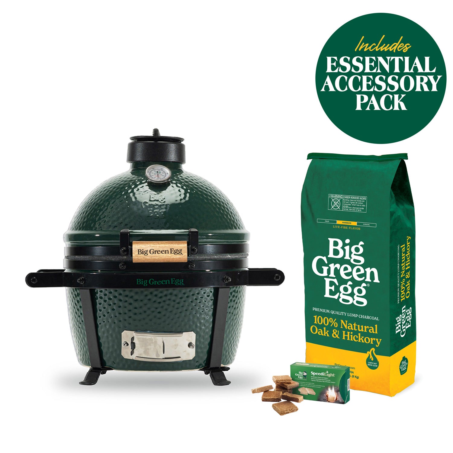 MiniMax Big Green Egg in a carrier, with charcoal, firestarters and a Essential accessory-pack badge