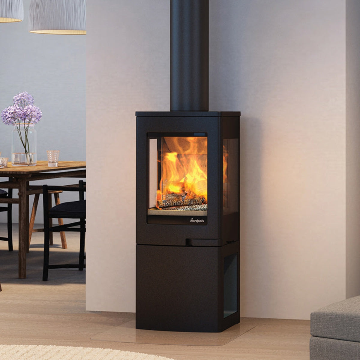 Nordpeis Uno 2 wood stove with log-store base in a dining-room setting