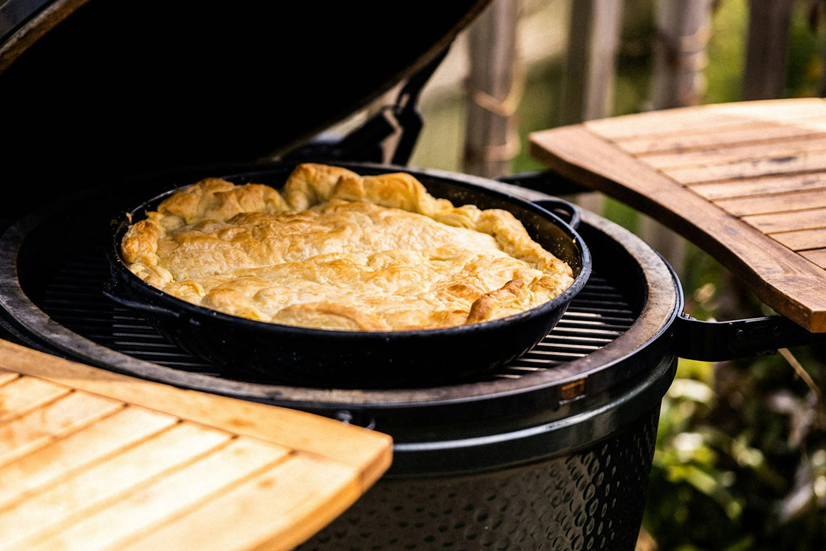 Golden baked pie cooked on the Big Green Egg Paella Pan.