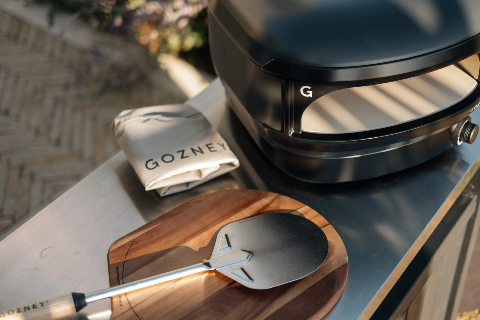 Gozney Arc Lite Essentials Bundle in a cooking setting; food and worktop are not included