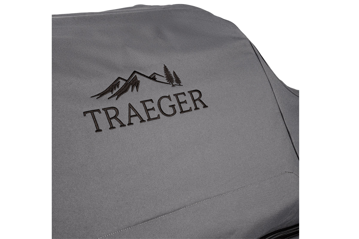 Close-up of the embroidered Traeger logo on the grey grill cover